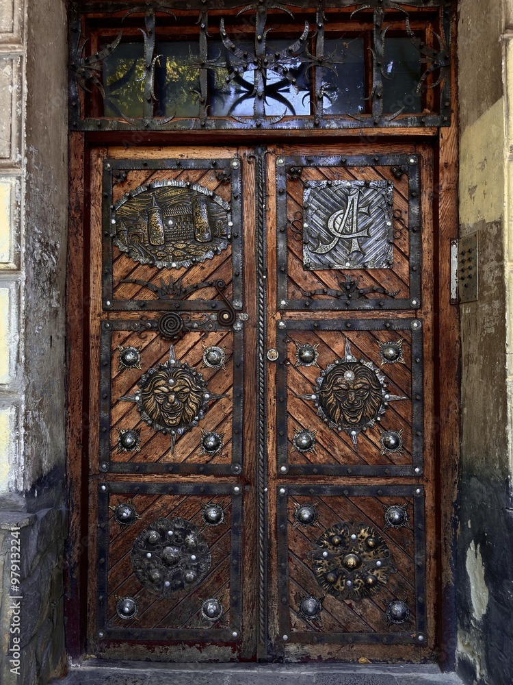 Ornate wooden door with intricate carvings and metal accents, showcasing traditional craftsmanship in a historical building entrance. Ornate wooden door with intricate carvings and metal accents, showcasing traditional craftsmanship in a historical building entrance.
