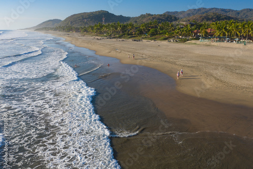 Aerial view of beautiful Playa Troncones with tranquil waves and sandy shoreline, Troncones, Mexico. photo