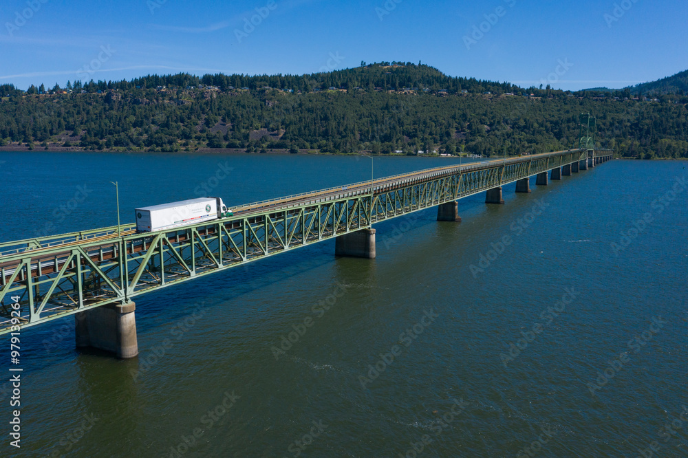 Aerial view of hood river bridge crossing the columbia river with a semi truck, hood river, oregon, united states. Aerial view of hood river bridge crossing the columbia river with a semi truck, hood river, oregon, united states.
