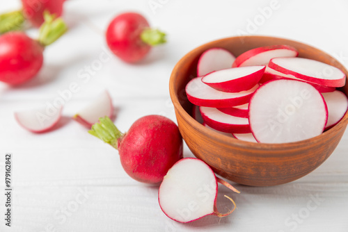 Fresh radish on textured wooden background. Organic natural garden radish slices. clipping root crop. Vegetables. Vegan. Diet products. Healthy food. Place for text. Copy space.