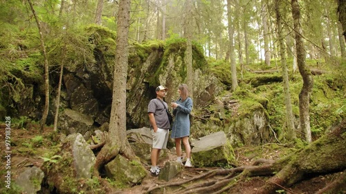 A beautiful couple taking selfie in the forest in Karelia. photo