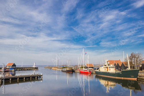 Fishing ships and sailboat in the harbor of Hindeloopen, Netherlands photo