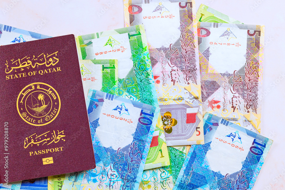 State of Qatar passport with is Qatari banknotes currency Riyals cash various nominal State of Qatar passport with is Qatari banknotes currency Riyals cash various nominal