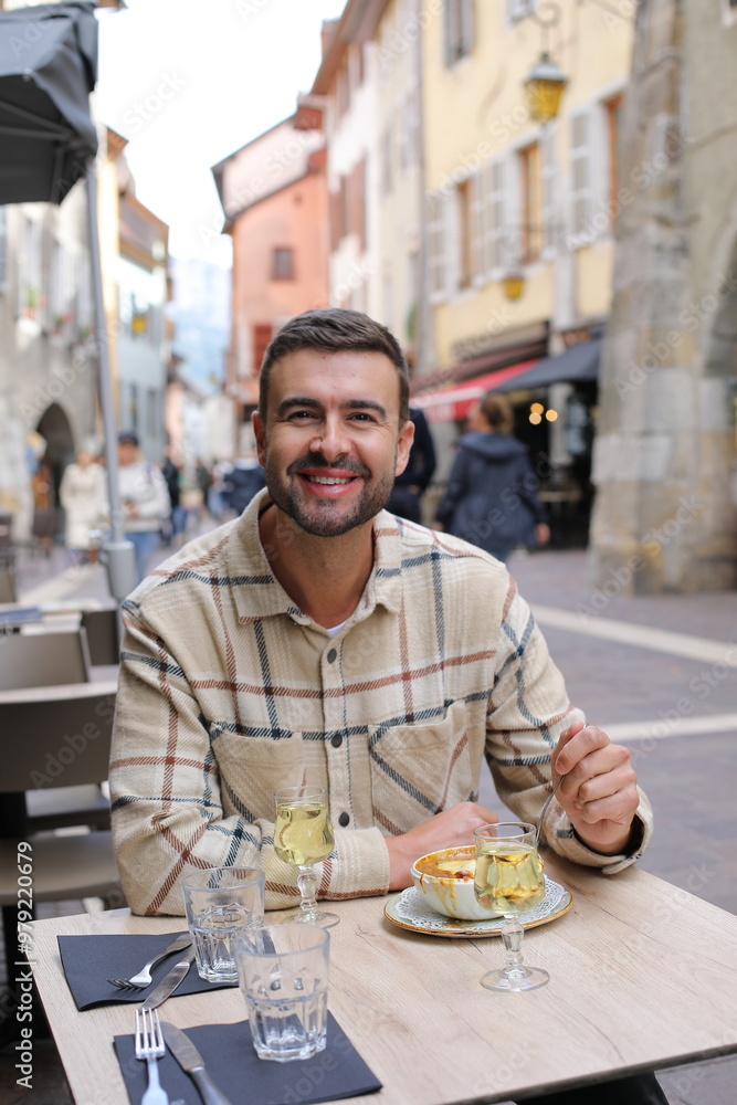 Handsome man eating in European cafe terrace Handsome man eating in European cafe terrace