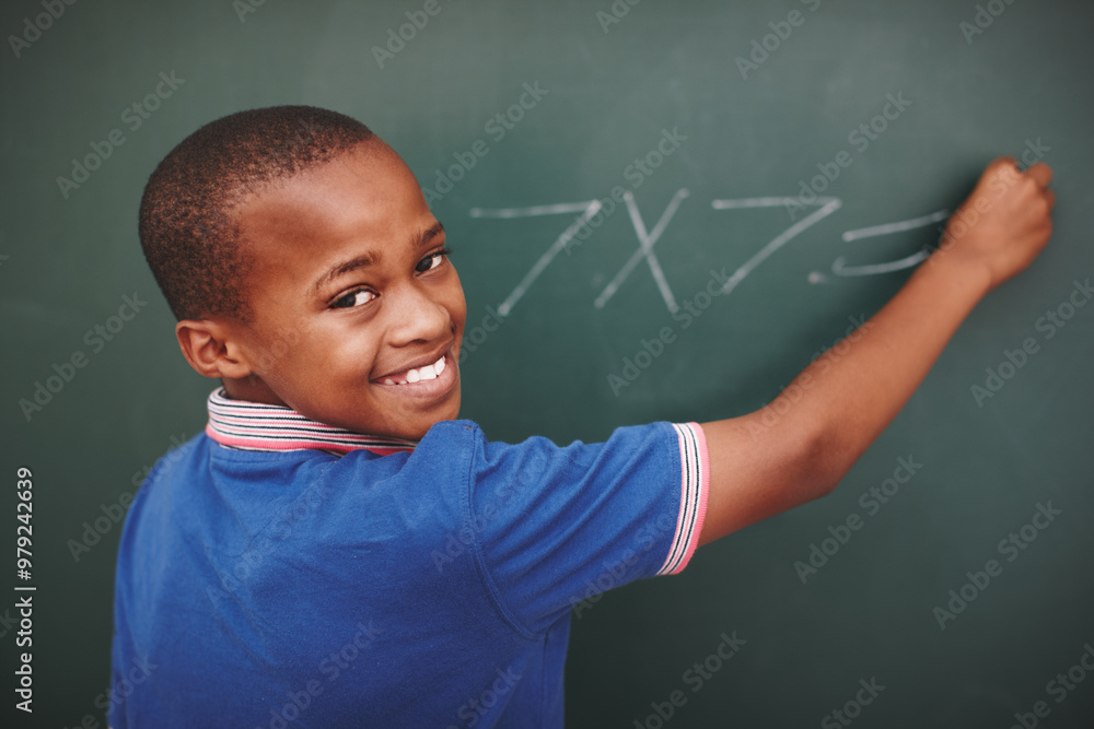 © STEEXBuyout/peopleimages.com - Math, student and portrait at chalkboard in classroom with problem solving, education or learning development. Scholarship, black boy or answer question with multiplication or number lesson at school