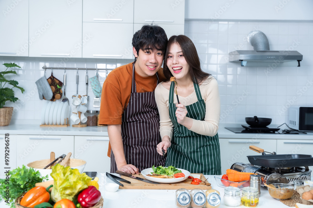 Happy portrait of loving young asian of having fun standing a cheerful preparing food and enjoy cook cooking with vegetables, meat, bread while standing on a kitchen Condo life or home Happy portrait of loving young asian of having fun standing a cheerful preparing food and enjoy cook cooking with vegetables, meat, bread while standing on a kitchen Condo life or home
