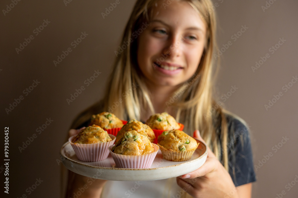 Kid Holding a Plate with Healthy Savory Muffin with Pea and Ham Close-Up Kid Holding a Plate with Healthy Savory Muffin with Pea and Ham Close-Up