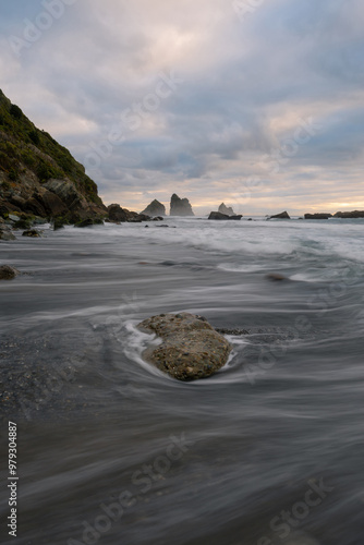Cloudy day view on the shore of Motukiekie Beach, New Zealand. photo