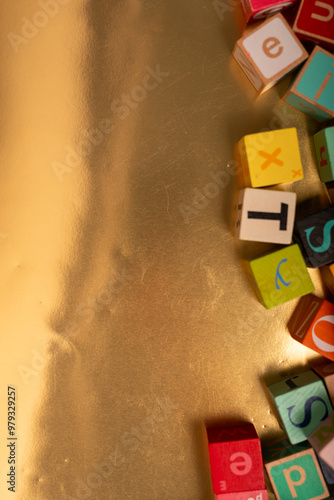 Colorful alphabet blocks scattered on a gold background Ready for learning alphabetblocks goldbackground learningfun photo