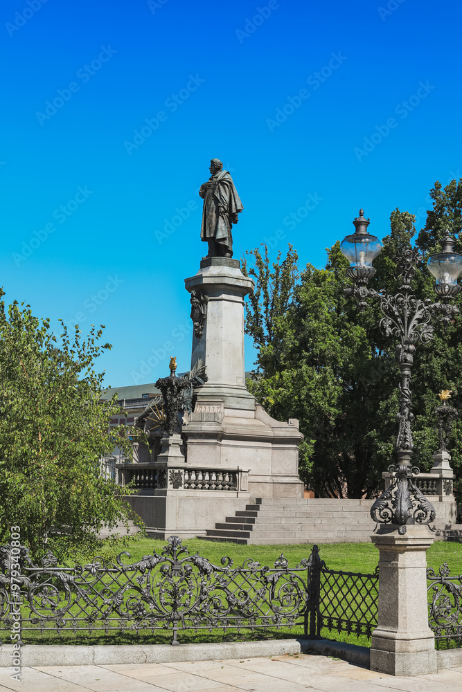 Statue of a prominent historical figure in a park setting in Warsaw during a clear daytime Statue of a prominent historical figure in a park setting in Warsaw during a clear daytime