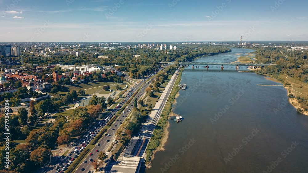 Aerial view of the Vistula River and greenery along the banks in Warsaw, showcasing urban life and nature on a sunny day Aerial view of the Vistula River and greenery along the banks in Warsaw, showcasing urban life and nature on a sunny day