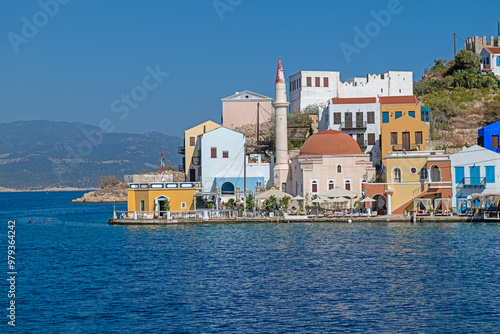 Fototapeta Naklejka Na Ścianę i Meble -  Old Ottoman mosque and colourful island houses on the Greek island of Meis.