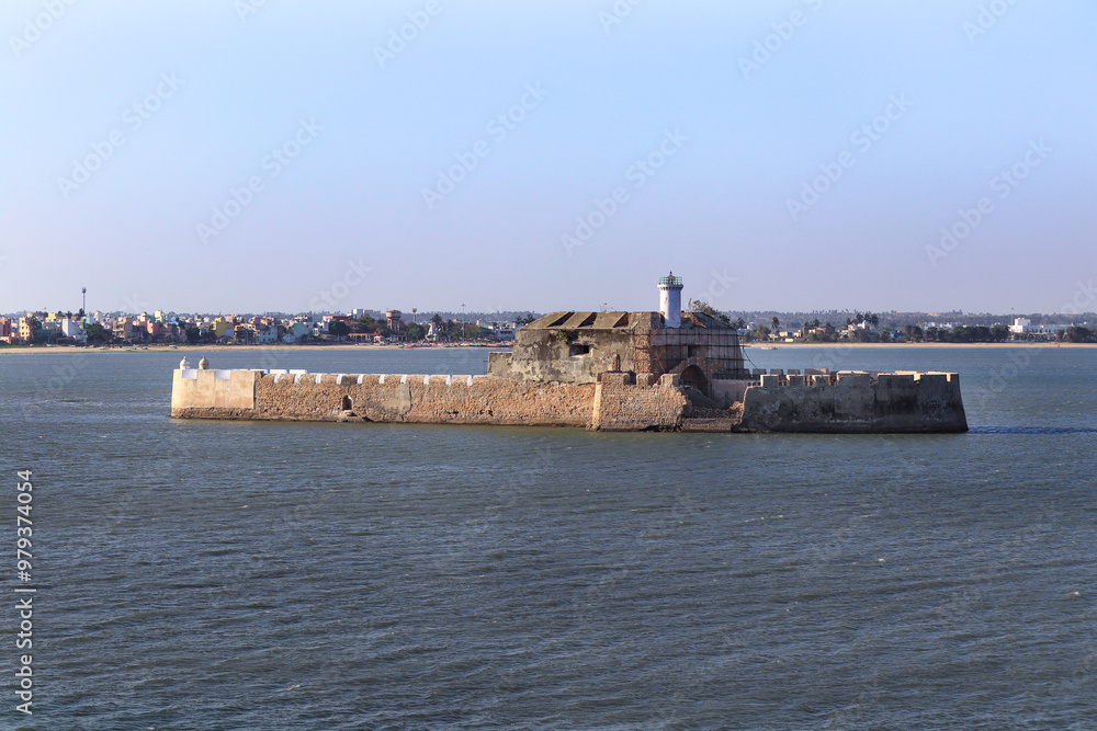 Pani Kotha prison in the distance. Shows the blue water, waves, ocean Walls of diu fort with view of Old Diu City, Portuguese, located in Diu district of Union Territory Daman and Diu India Pani Kotha prison in the distance. Shows the blue water, waves, ocean Walls of diu fort with view of Old Diu City, Portuguese, located in Diu district of Union Territory Daman and Diu India