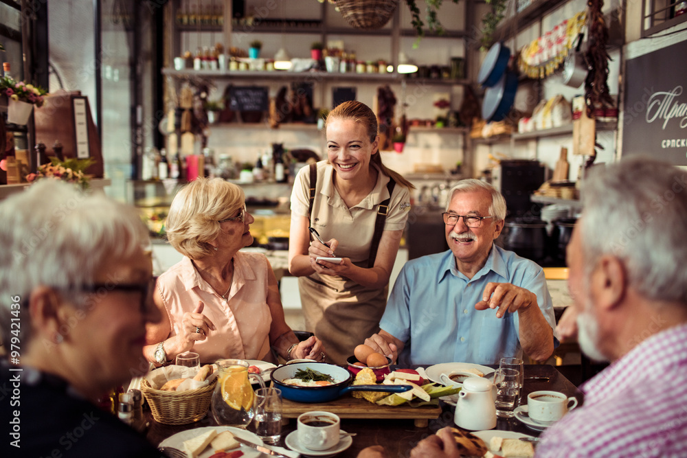 Smiling young waitress taking order from diverse senior people at a bistro Smiling young waitress taking order from diverse senior people at a bistro