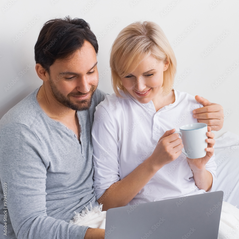 Internet technology, online shopping, e-commerce concept - happy smiling family, couple, bearded man, blond beautiful woman husband, wife using laptop notebook in home bed room bedroom. Square. Internet technology, online shopping, e-commerce concept - happy smiling family, couple, bearded man, blond beautiful woman husband, wife using laptop notebook in home bed room bedroom. Square.