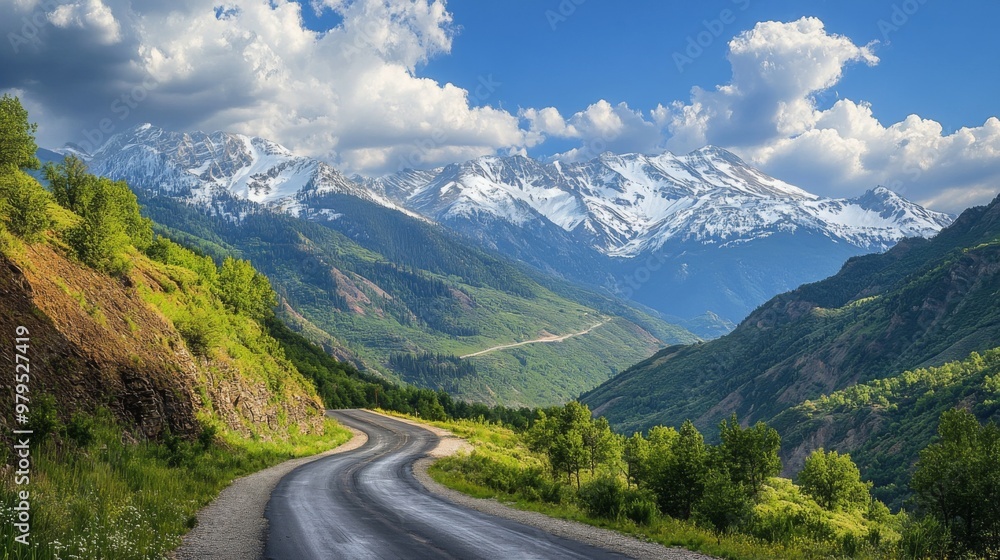 A scenic mountain road with dramatic switchbacks and breathtaking views of snow-capped peaks and valleys, capturing the grandeur of the landscape. A scenic mountain road with dramatic switchbacks and breathtaking views of snow-capped peaks and valleys, capturing the grandeur of the landscape.