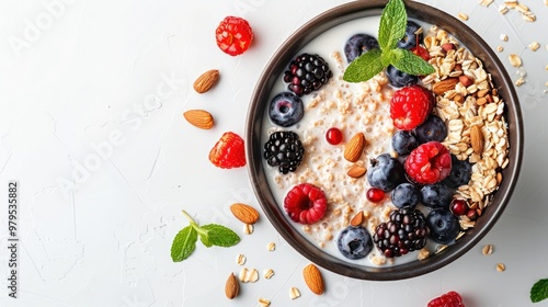 A bowl of overnight oats made with almond milk, topped with fresh berries, nuts, and seeds