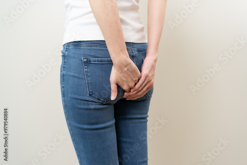 Tableau sur toile Health care, pain asian young woman suffering from hemorrhoid, anus, diarrhea and constipation, girl hand touching, holds butt, anal have abdominal, intestine problem, abscess disease and smell fart