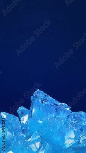 Close up of vibrant blue crystals against a dark blue background.