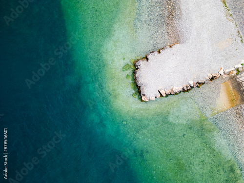 Aerial drone view of Lago di Garda (lake Garda) coastline, Italy. The beach and fresh blue water.