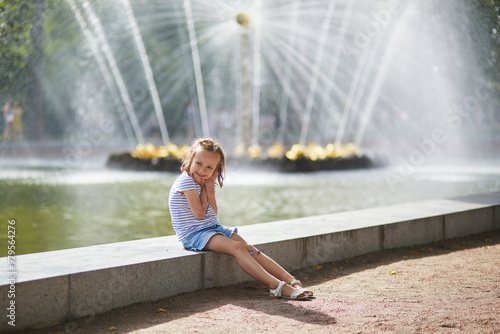 Adorable preschooler girl walking in Petergof, St. Peterburg, Russia. photo