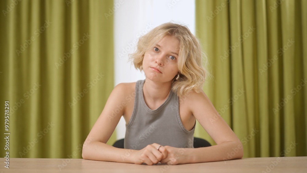 Female college student studying at home, sitting at desk, listening watching lesson online on computer, thinking and nodding head. Modern online education. Female college student studying at home, sitting at desk, listening watching lesson online on computer, thinking and nodding head. Modern online education.