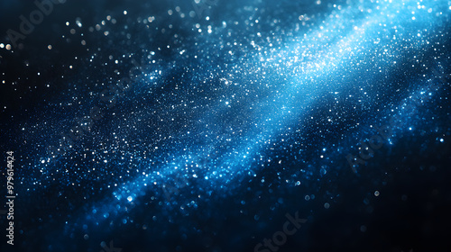 Dark blue abstract background with glittering powder all over the area.