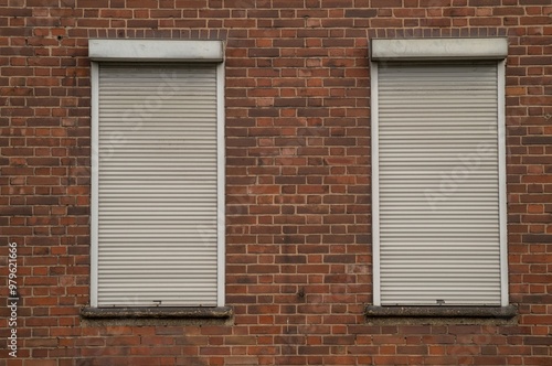 brick wall with old windows and shutters