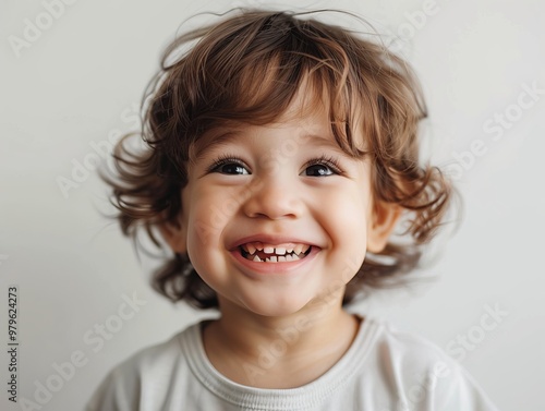 Close-up of a cheerful child with a white background, highlighting their bright and joyful expression