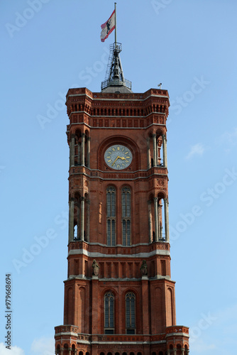 Majestic Rotes Rathaus tower rising against a blue sky in Berlin, Germany and showcases its stunning red brick architecture and iconic clock