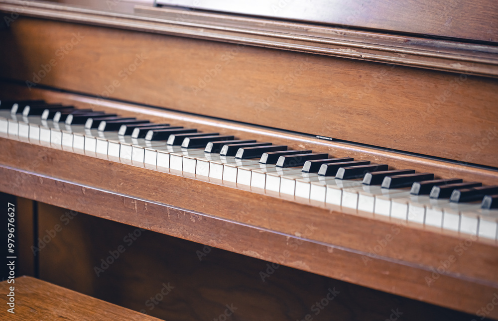 Piano keys on wooden brown musical instrument.