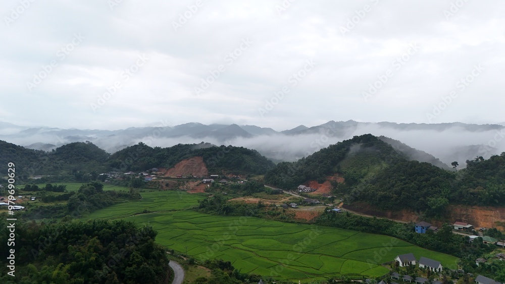Villages in the valley and green rice fields are beautiful Villages in the valley and green rice fields are beautiful