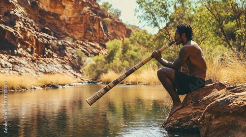 Australian Aboriginal Didgeridoo Player Performing in a Scenic Setting photo