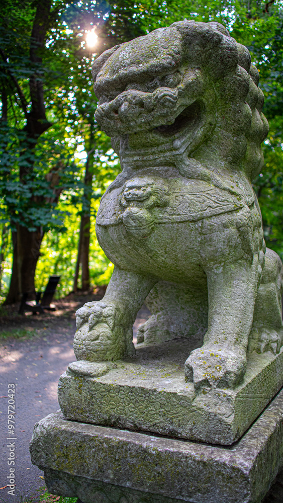 Stone Carving of Chinese Lion in Woods at Sunset Stone Carving of Chinese Lion in Woods at Sunset