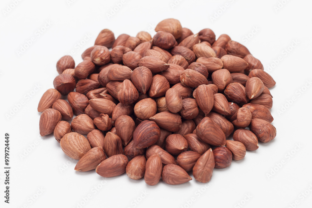 Pile of hazelnuts on white background. Pile of hazelnuts on white background.