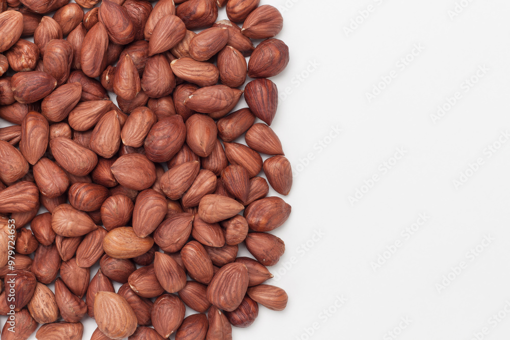Pile of hazelnuts on white background with copy space. Pile of hazelnuts on white background with copy space.