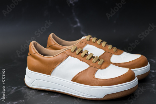 Elegant sneakers in eco-leather in white and light brown, profile view