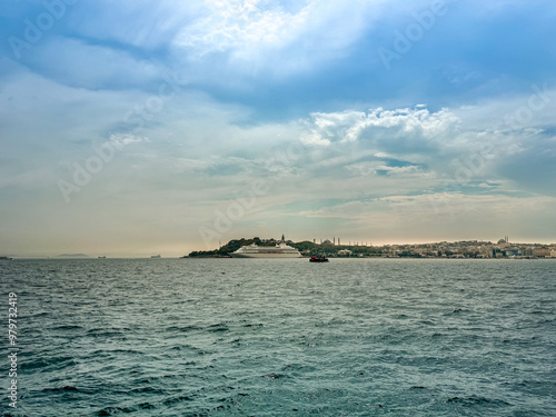 Istanbul Bosphorus, Sarayburnu and  Topkapı Palace silhouette, cloudy blue sky in the background photo