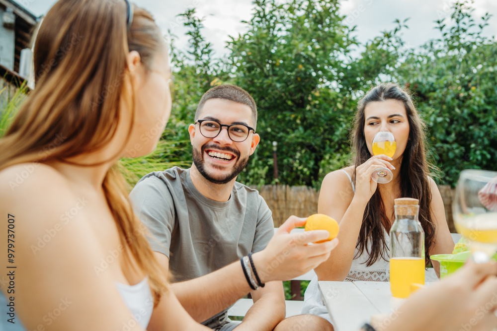 Group of three friends or family having picnic in backyard or garden Group of three friends or family having picnic in backyard or garden