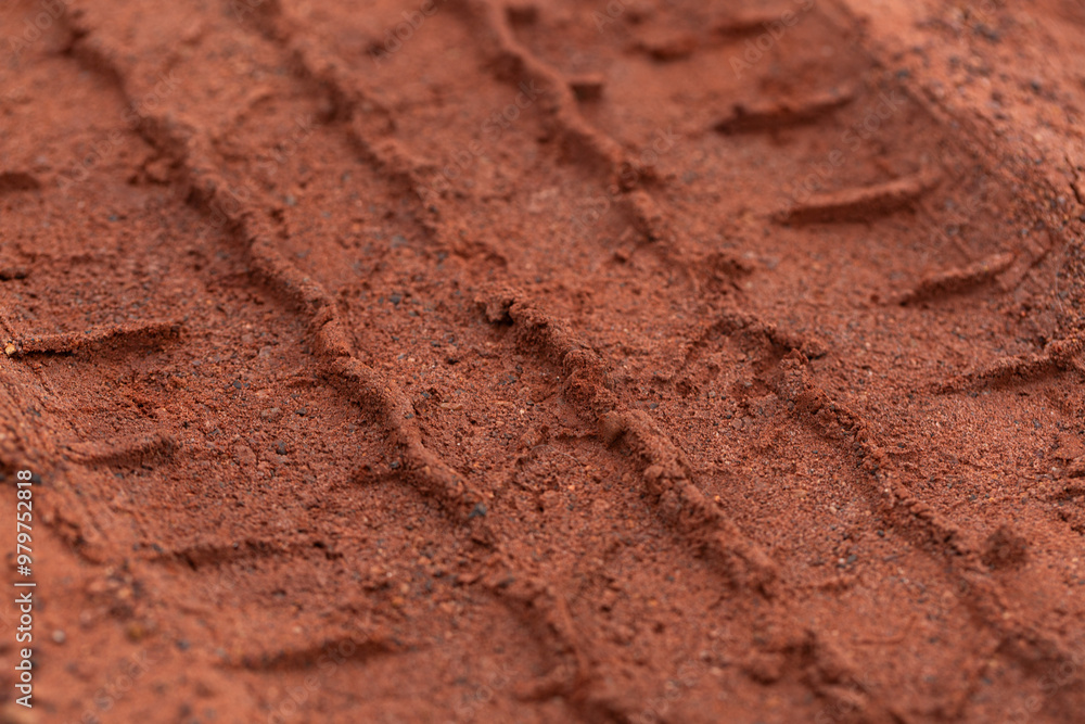 Close-up of car tire pattern on the ground,Close up of tire track or tire tread left behind in the mud or dirt Close-up of car tire pattern on the ground,Close up of tire track or tire tread left behind in the mud or dirt