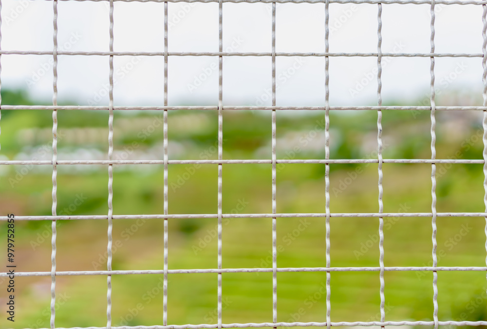 Steel, iron, metal, wire mesh a square cell on mountain background. Abstract shapes, patterns and textures. Steel, iron, metal, wire mesh a square cell on mountain background. Abstract shapes, patterns and textures.