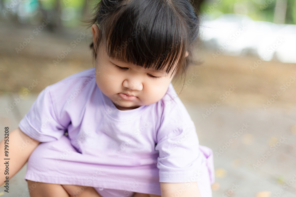 Asian girl toddler sitting in outdoor park,Little asian girl Little cute asian girl in the garden Asian girl toddler sitting in outdoor park,Little asian girl Little cute asian girl in the garden