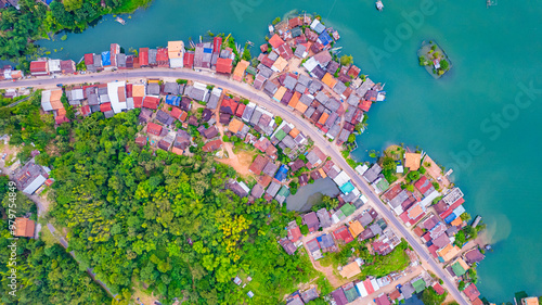 Top view of a riverside village with a road running through it in Laos, Asia. photo