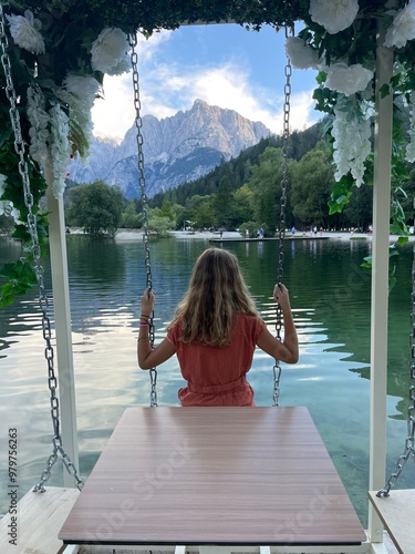 woman sitting on the edge of the lake