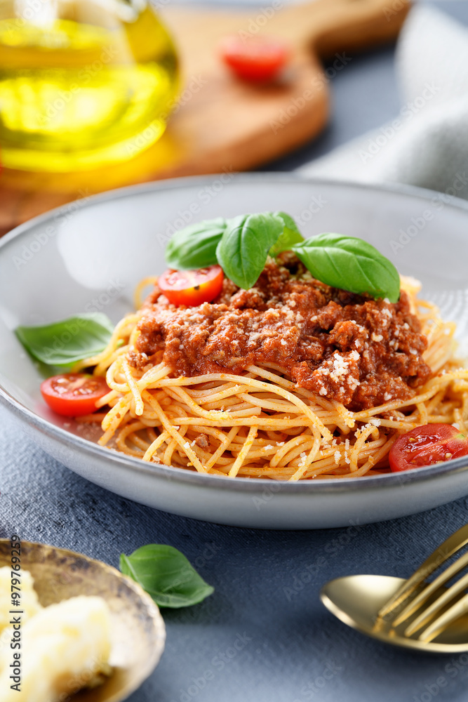 Traditional italian food - spaghetti bolognese with fresh basil leaves and parmesan cheese Traditional italian food - spaghetti bolognese with fresh basil leaves and parmesan cheese