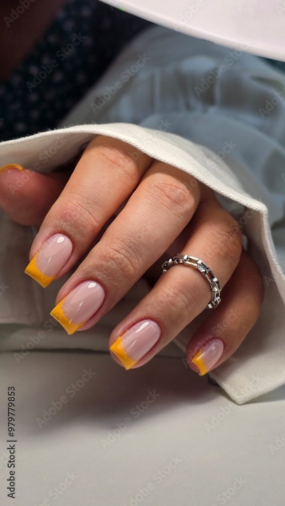 Obraz premium The beauty of the natural nails. Perfect clean manicure. New trendy nail arts on young women hand. Beautiful nail polish in hand