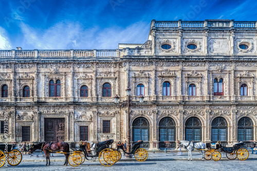 Carriages Lined up in Front of Seville City Hall\'s Stunning Facade photo