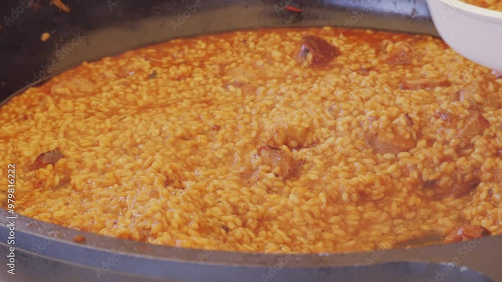 Chef Cooking traditional Spanish Paella on a stove, food festival in barcelona spain. Chef cooking food on fire from mussels, shrimp, squid rice, Catalan catalonian cuisine, street food truck. Chef Cooking traditional Spanish Paella on a stove, food festival in barcelona spain. Chef cooking food on fire from mussels, shrimp, squid rice, Catalan catalonian cuisine, street food truck.