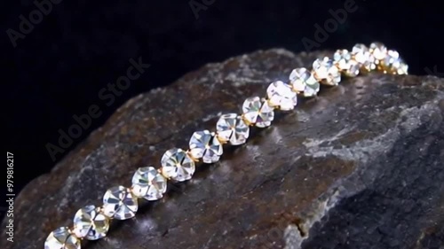 Gold diamond teardrop necklace on a jewelry bust. Diamond Necklace Display on a rock stone