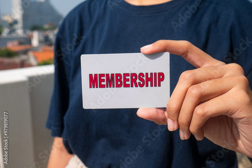 close up of woman's hand holding membership card